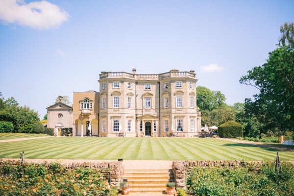 View looking across neat striped lawn towards Bourton Hall.