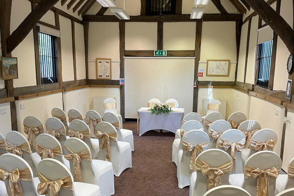 Interior photo of a ceremony at the Tithe Barn