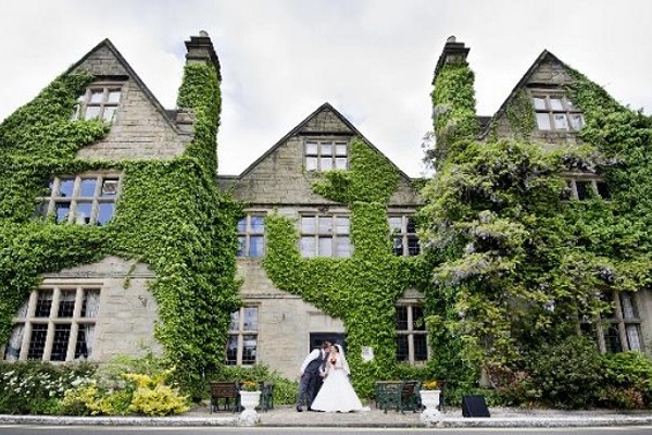 Bride and room stood outside Weston Hall Hotel